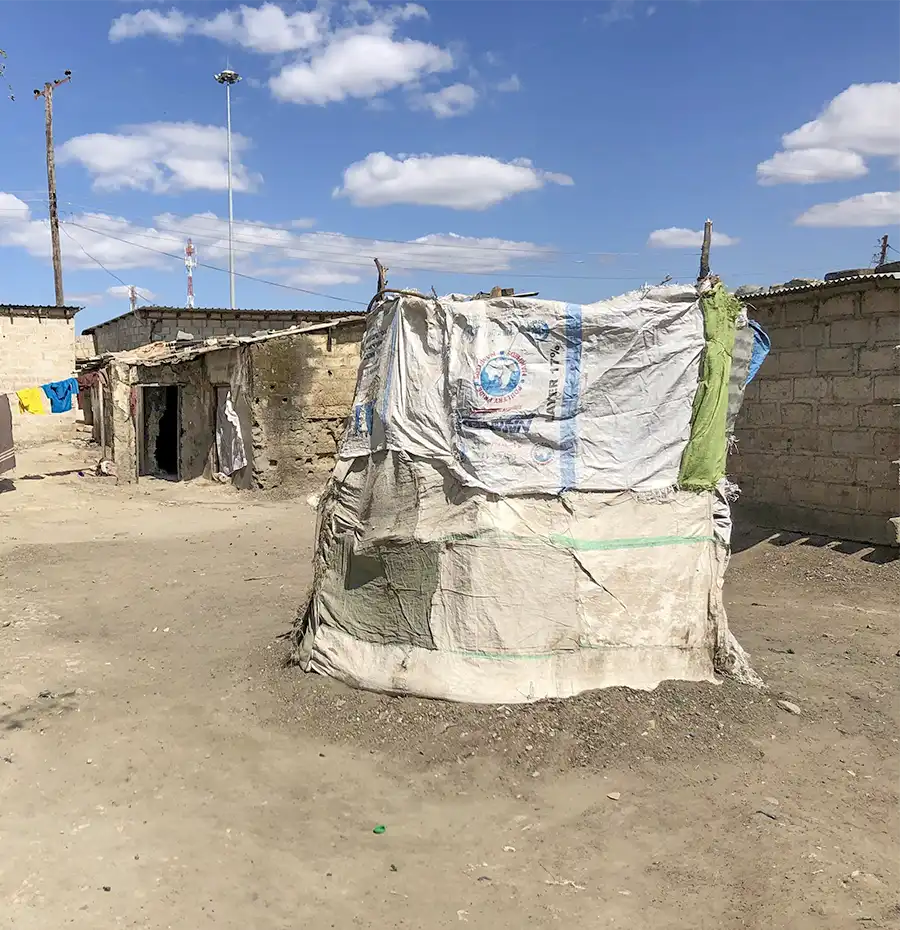 A toilet in a low-income community on the periphery of Lusaka. The cloth-covered toilets have holes to hold excrement, but there are no lids, and the contents overflow during the rainy season.